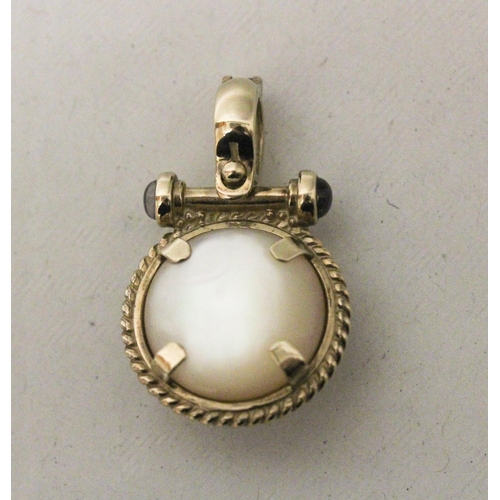 576 - A modern 9ct gold mabe pearl and cabochon sapphire pendant enhancer, the circular pearl within rope ... 