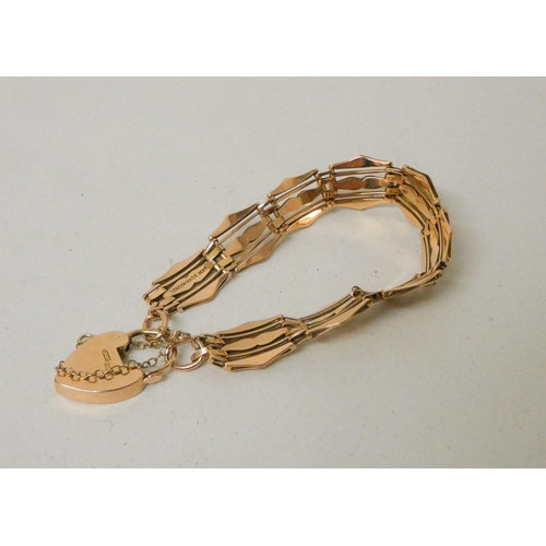 582 - 15ct rose gold gate style panel bracelet, engraved and shaped links with safety chain and heart shap... 