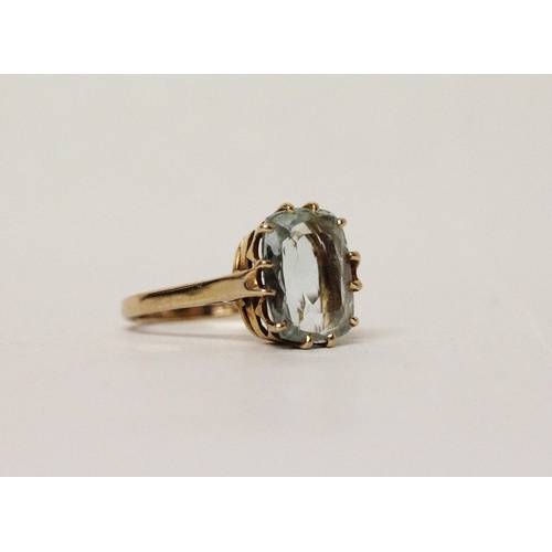 594 - A vintage large aquamarine single stone dress ring, claw set on a 9ct gold band. Ring size O gross w... 