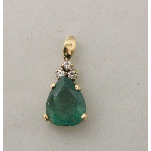 634 - A large emerald and diamond teardrop shaped pendant. The heart shaped emerald claw set with three br... 