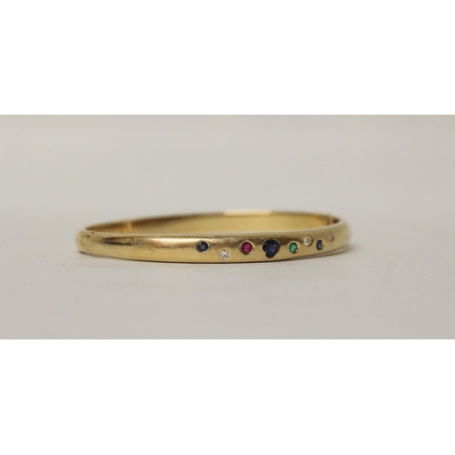 637 - A multi gem set 18ct yellow gold hinged bangle. Pave set with diamonds, sapphires, emerald and ruby,... 