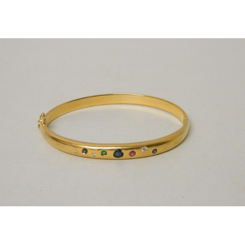 637 - A multi gem set 18ct yellow gold hinged bangle. Pave set with diamonds, sapphires, emerald and ruby,... 