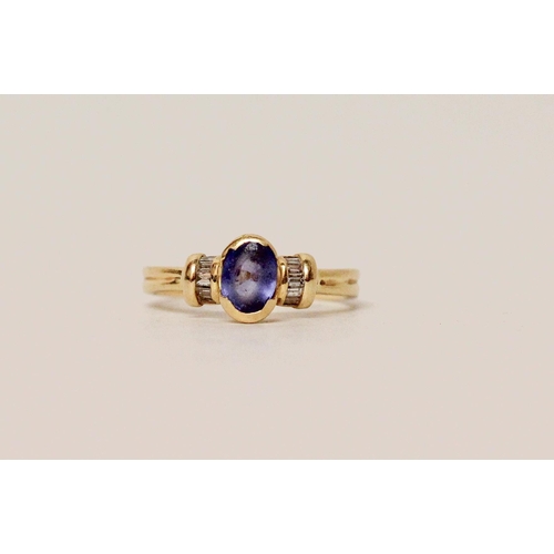 642 - A Ceylon sapphire and diamond ring, the oval sapphire flanked by baguette cut diamonds, on 18ct yell... 