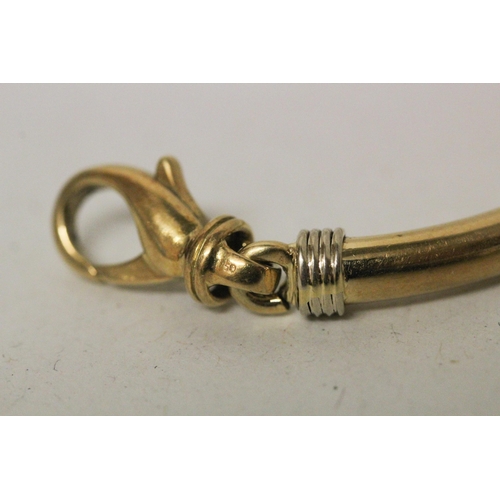 655 - An 18ct yellow gold bangle, of hinged jointed design, with large lobster clasp. Marked 750. Gross we... 