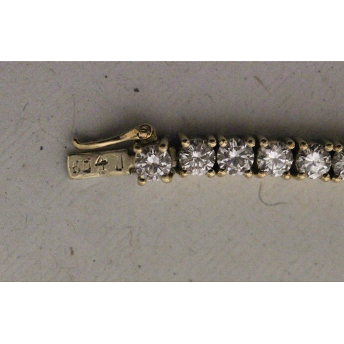 658 - A diamond line bracelet, of brilliant cut diamonds in 18ct yellow gold. Marked 18K, 750, Clasp marke... 