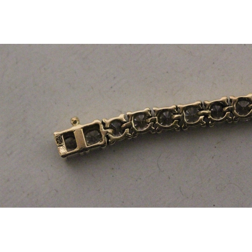 658 - A diamond line bracelet, of brilliant cut diamonds in 18ct yellow gold. Marked 18K, 750, Clasp marke... 