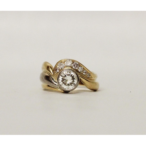 662 - A diamond ring, with a rub over set circular brilliant cut diamond within shaped bands of 18ct yello... 