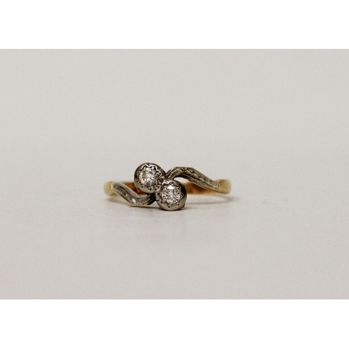 670 - A vintage 18ct & platinum mounted two stone cross over deign diamond ring. Band marked 18ct. Ring si... 