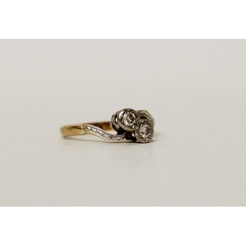 670 - A vintage 18ct & platinum mounted two stone cross over deign diamond ring. Band marked 18ct. Ring si... 