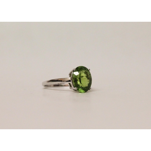 672 - Modern white gold and peridot dress ring, hallmarked 9ct white gold band, ring size N, gross weight ... 