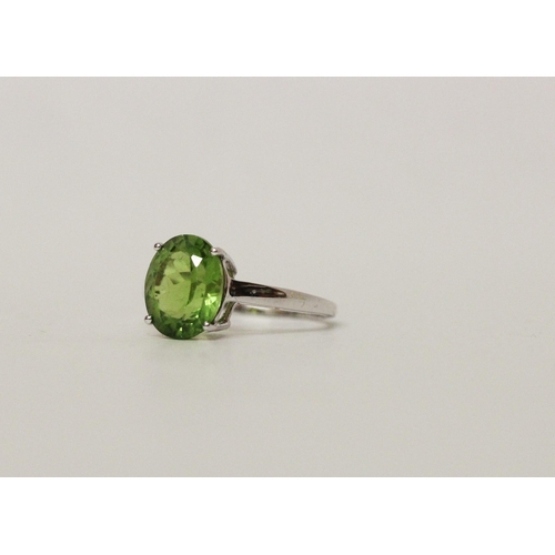 672 - Modern white gold and peridot dress ring, hallmarked 9ct white gold band, ring size N, gross weight ... 