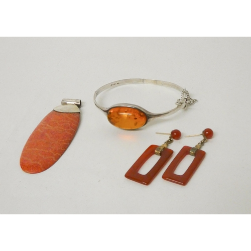 693 - Silver and amber bangle, large silver set stone pendant and a pair of drop earrings