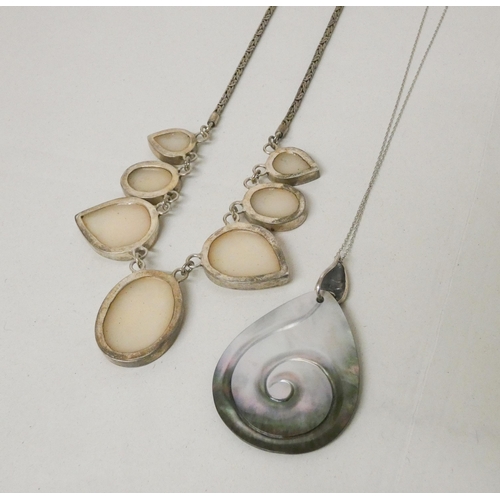 695 - A silver and shell mounted necklace, clasp marked 925, and a carved shell pendant on silver chain.