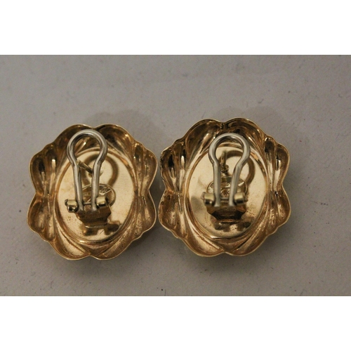 711 - A pair of Italian 18ct yellow gold earrings, in the cameo style  with omega safety fittings. Hallmar... 