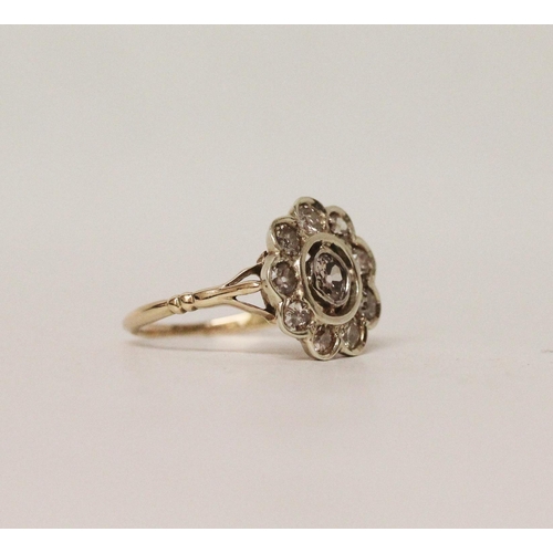 713 - A vintage diamond flower cluster ring, with old cut diamonds collet set in large floral design, on y... 