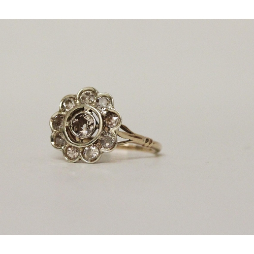 713 - A vintage diamond flower cluster ring, with old cut diamonds collet set in large floral design, on y... 