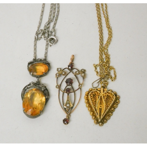 714 - An Italian silver gilt filigree heart pendant, An Art Nouveau 9ct gold seed pearl and garnet pendant... 