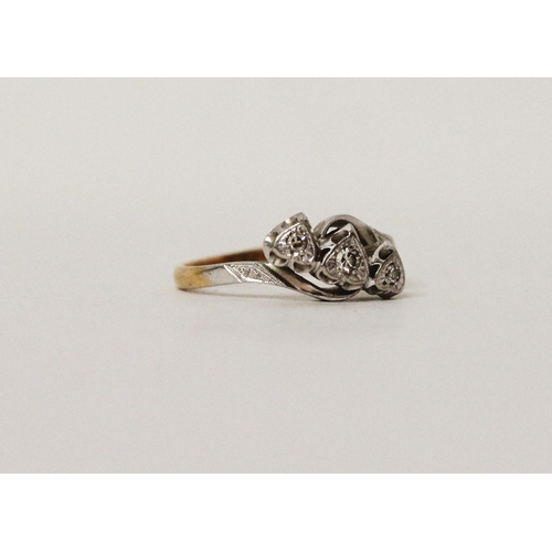 718 - A vintage 18ct gold and platinum mounted three stone diamond ring, in heart shaped illusion setting.... 