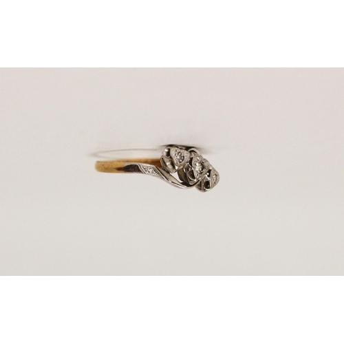 718 - A vintage 18ct gold and platinum mounted three stone diamond ring, in heart shaped illusion setting.... 