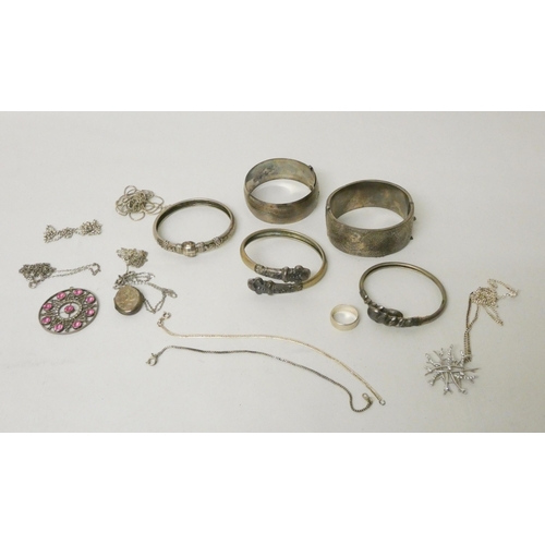 739 - A wide silver hallmarked hinged bangle, several other Eastern white metal bangles. silver chains and... 