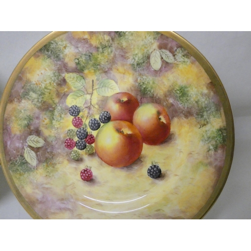 202 - A set of three Royal Worcester cabinet plates painted with autumnal fruits, signed J Smith