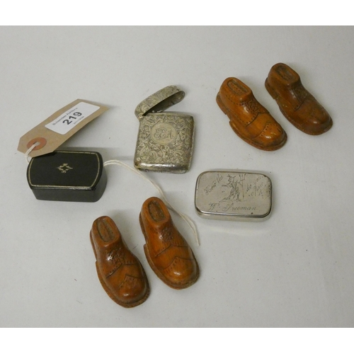 219 - A collection of treen snuff shoes, snuff boxes and a silver plated vesta case.