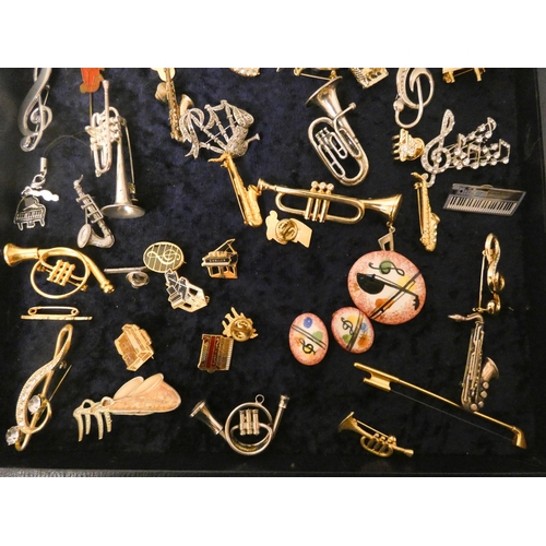 220 - A very large collection of musical themed brooches, cufflinks and miniature models of musical instru... 