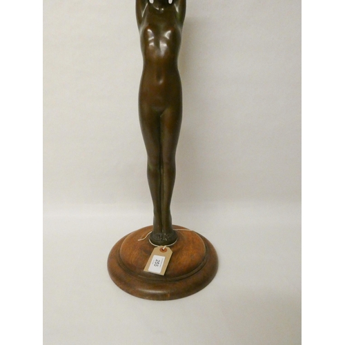 255 - Art Deco bronze comport modelled as a naked lady with arms raised supporting a dish, 26 tall