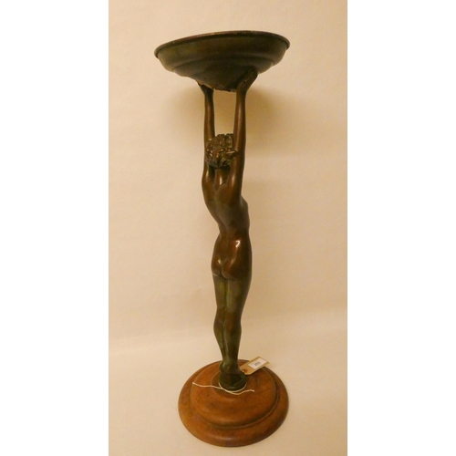 255 - Art Deco bronze comport modelled as a naked lady with arms raised supporting a dish, 26 tall