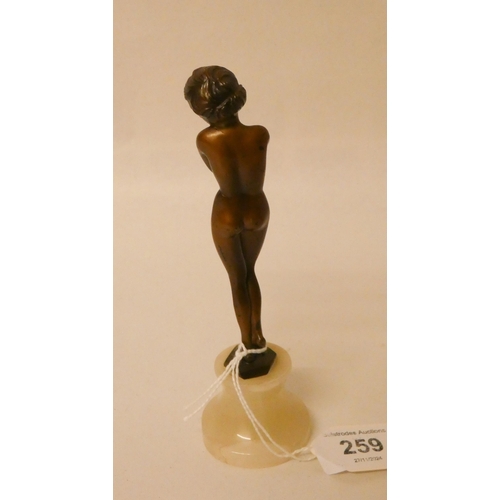 259 - An Art Deco bronze of a naked female, on circular onyx base. 6