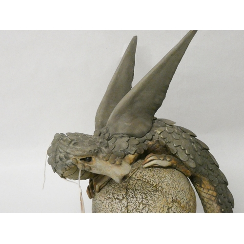 260 - A Studio Pottery model of a dragon coiled around an egg. 21cms tall.