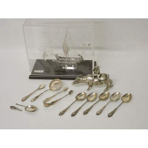 506 - Silver sifting spoon, teaspoons, cased silver Nef and an Oriental white metal model of a buffalo