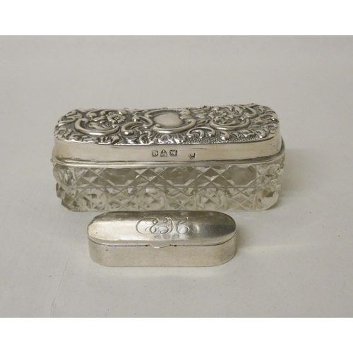 518 - A silver topped dressing table jar and a silver snuff box of oval form. 1.25 oz weighable silver