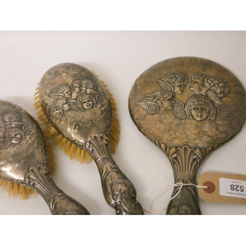 528 - A four piece Gainsborough cherub decorated silver backed hairbrush and dressing table hand mirror se... 