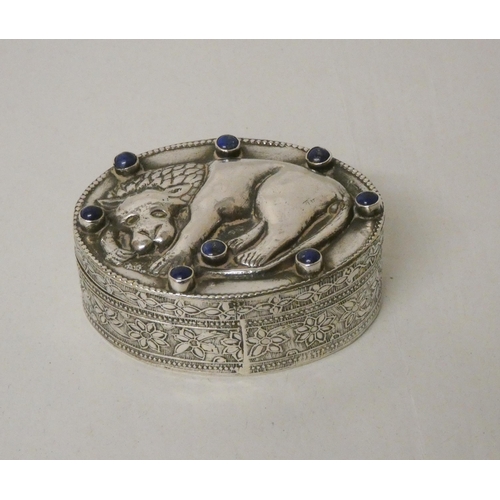 537 - A continental oval white metal box, the lid embossed with Roman Wolf and inset with lapis stones. 6.... 