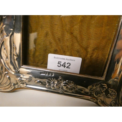 542 - An Art Nouveau silver embossed framed easel photo frame, embossed with semi clad classical female fi... 