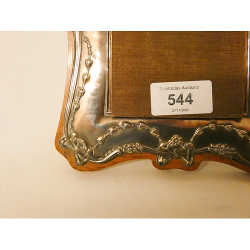 544 - An Edwardian silver photograph frame, decorated with classical swags and bows, on Oak backing. Maker... 