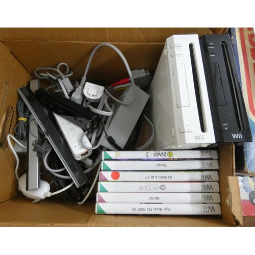 800 - Two Nintendo Wii machines, one black, one white, with a quantity of games and controllers etc