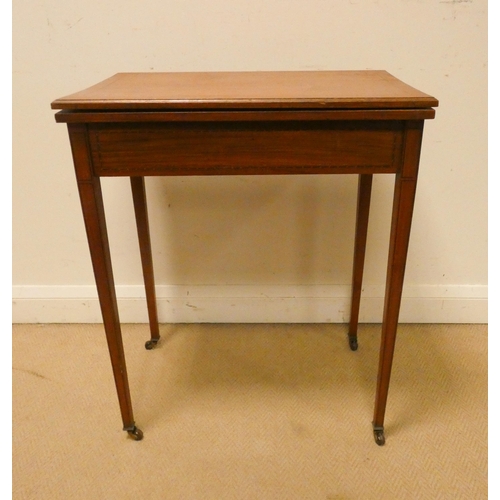 434 - An Edwardian lined inlaid satinwood folding top card table on square taper legs, 2' wide