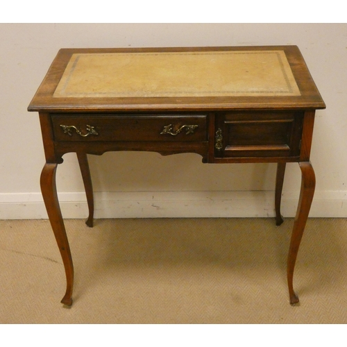 438 - An Edwardian mahogany writing table, fitted drawer and cupboard standing on cabriole style legs with... 