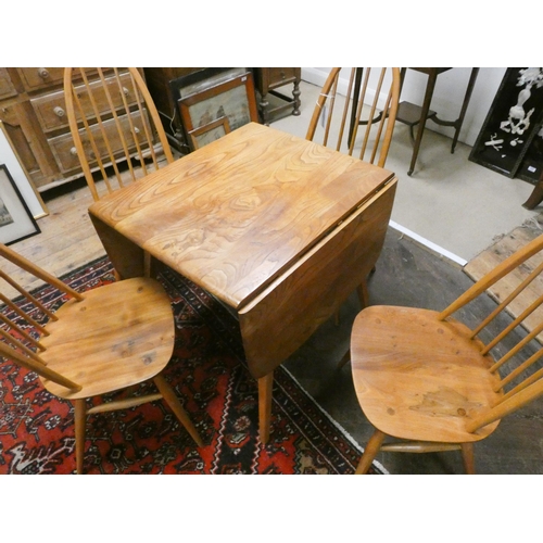 445 - An Ercol blonde elm Windsor drop leaf table and four Ercol Windsor Quaker chairs with blue label.