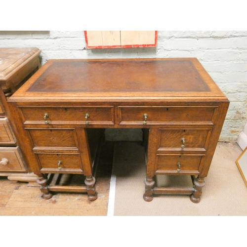 446 - An early 20th century oak knee-hole desk fitted six drawers with brown leather top, 3'6