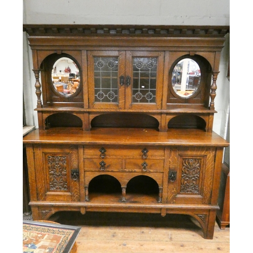 453 - An Edwardian oak dresser style sideboard with leaded glazed and mirror cabinet back, two drawers and... 