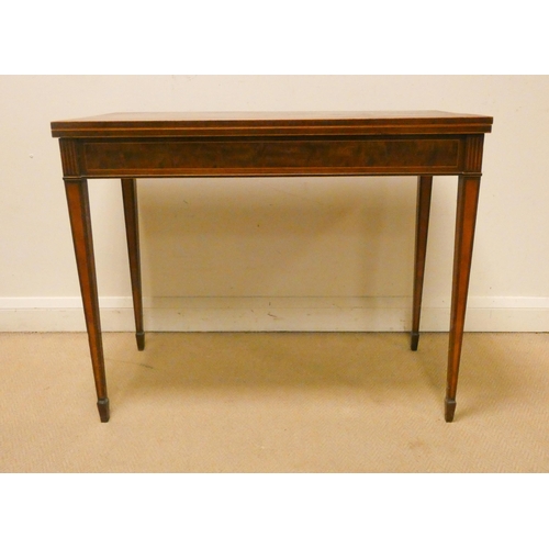 479 - An Edwardian inlaid mahogany folding top card table on square taper legs. 3' wide