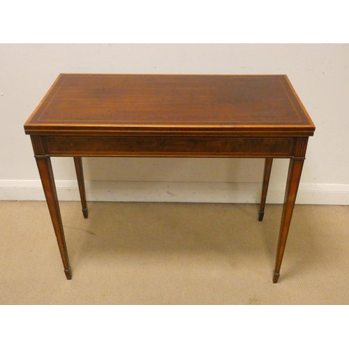 479 - An Edwardian inlaid mahogany folding top card table on square taper legs. 3' wide