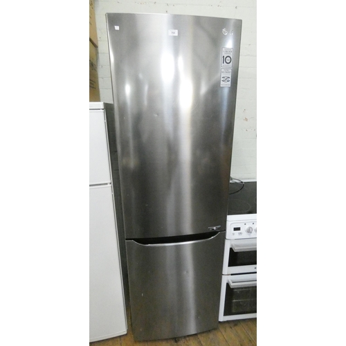 768 - A tall LG fridge freezer with slightly larger freezer compartment on top