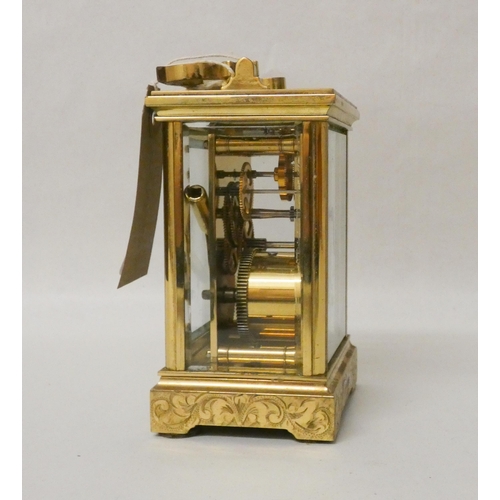 266 - A French gilt brass carriage clock with engraved carrying handle and case complete with key