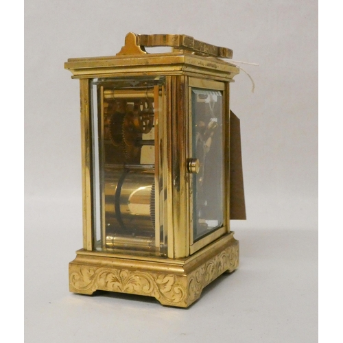 266 - A French gilt brass carriage clock with engraved carrying handle and case complete with key