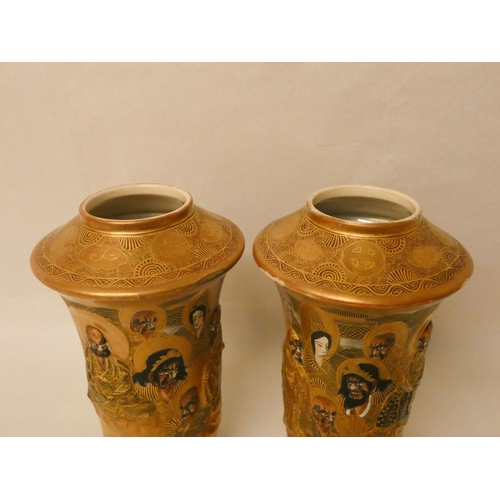 277 - A pair of Japanese Satsuma vases, relief moulded with figures against a gilt background. Gilt seal m... 