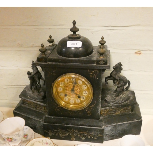 301 - A Victorian black marble mantel clock with horse mounts